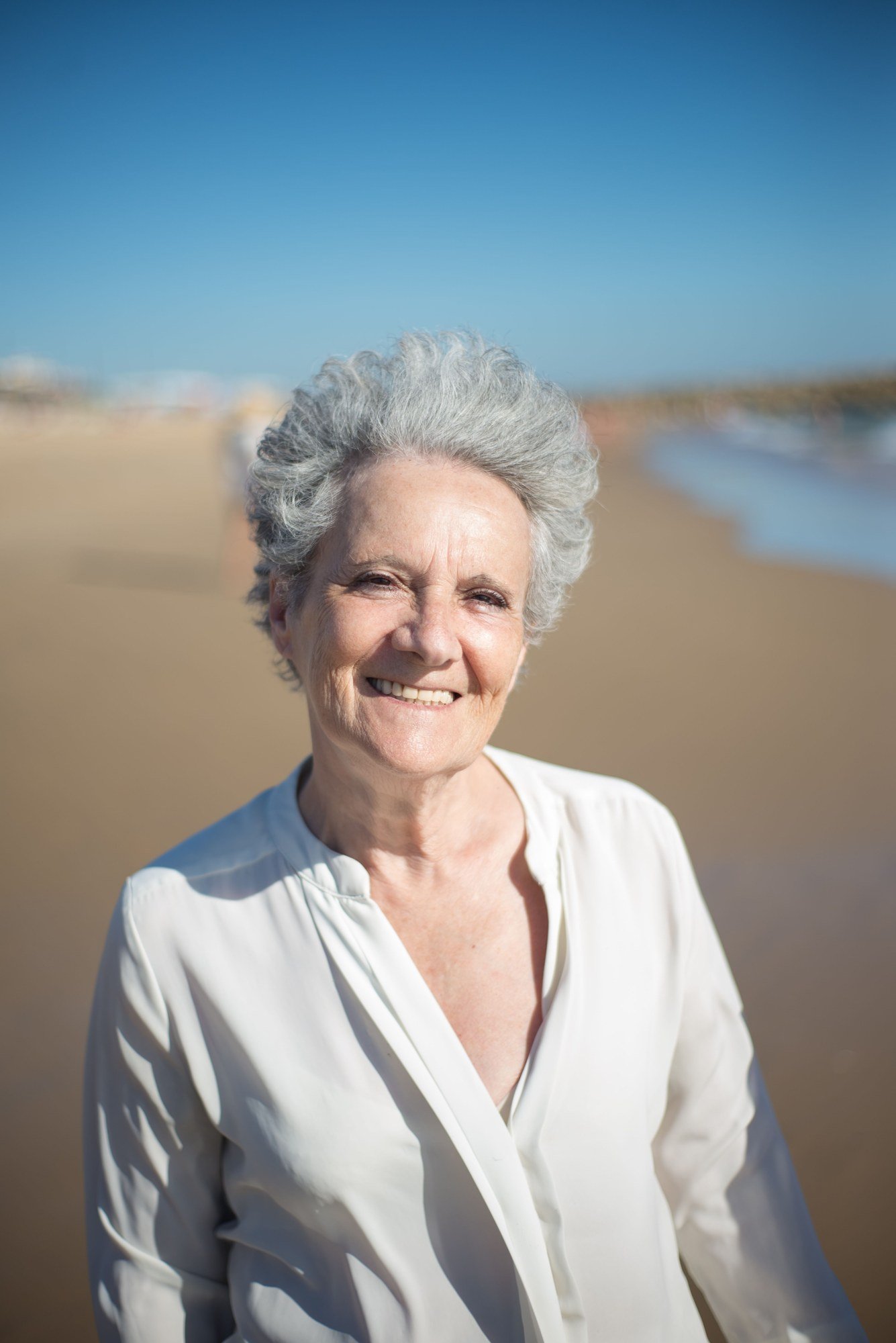 A relaxed, natural smile in soft coastal light